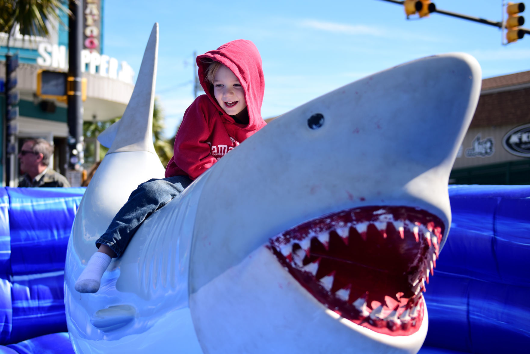 Taste of Folly kid on mechanical shark